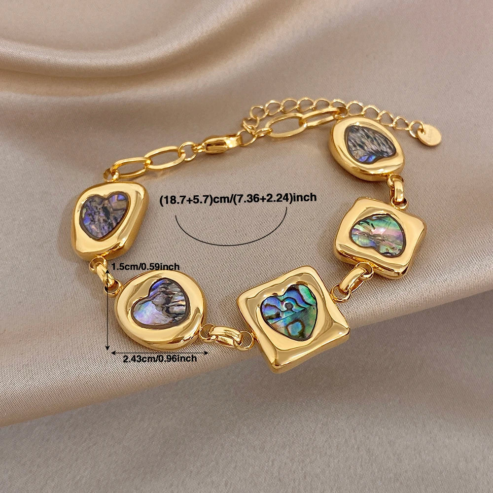 Gold-tone abalone-shell charm bracelet with heart, square, and teardrop link charms