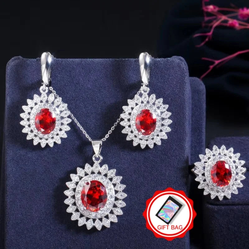Red oval cubic zirconia jewelry set with flower-halo earrings, pendant necklace, and ring