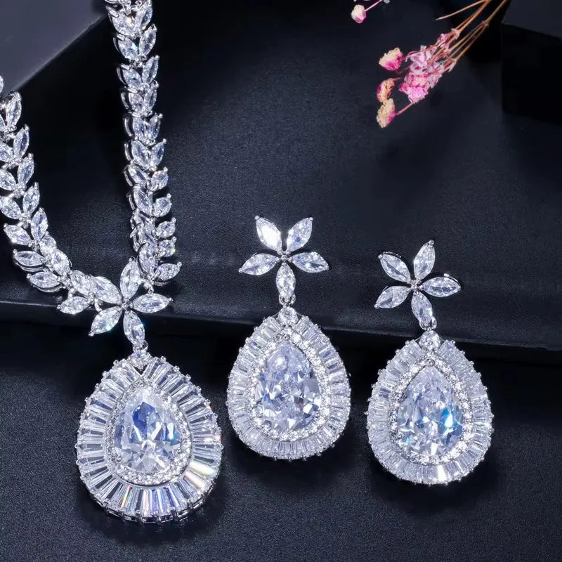 Close-up of a clear teardrop zircon necklace pendant and matching earrings
