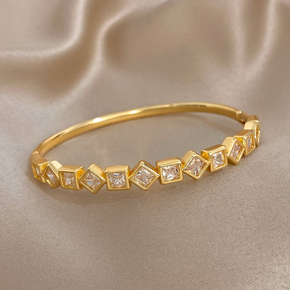 Gold-tone geometric cuff bracelet with linked square clear-stone settings