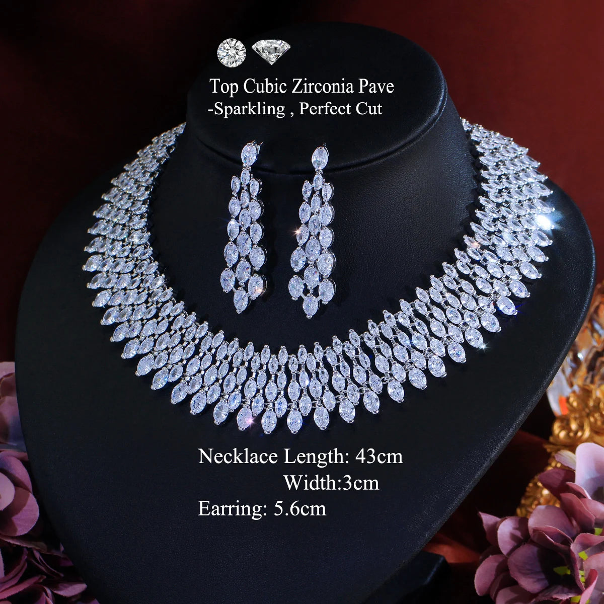 Cubic zirconia pave necklace and drop earrings set on black bust display, silver-toned