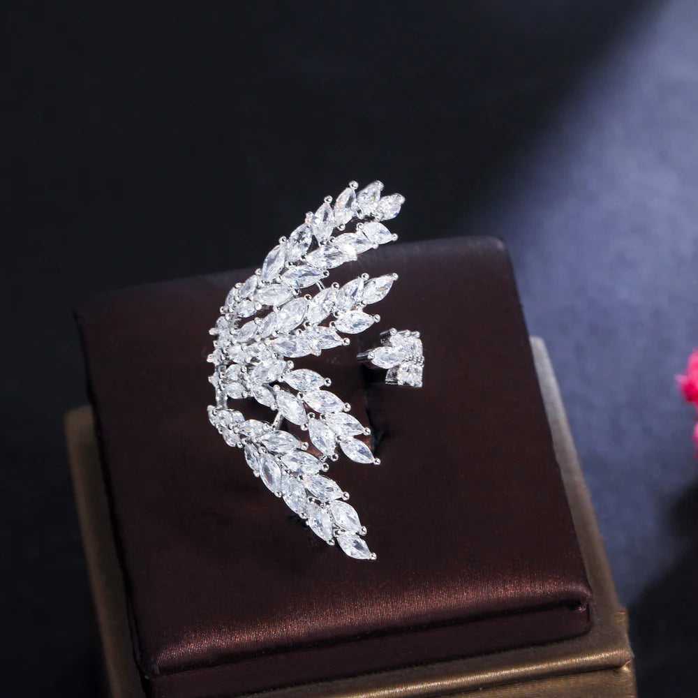 Silver-tone open ring with a curved, stone-set leaf motif