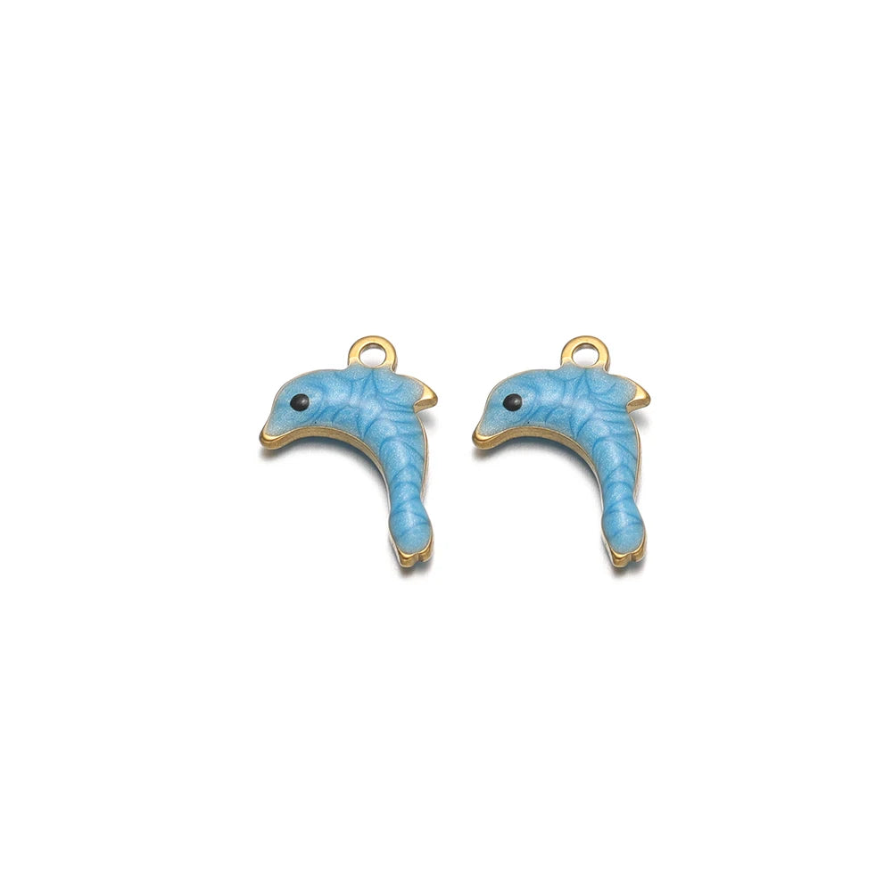 Two blue enamel dolphin charms with gold-tone loops and small eyes