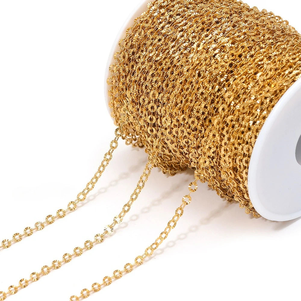 Gold textured chain mesh on a spool with linked strands hanging