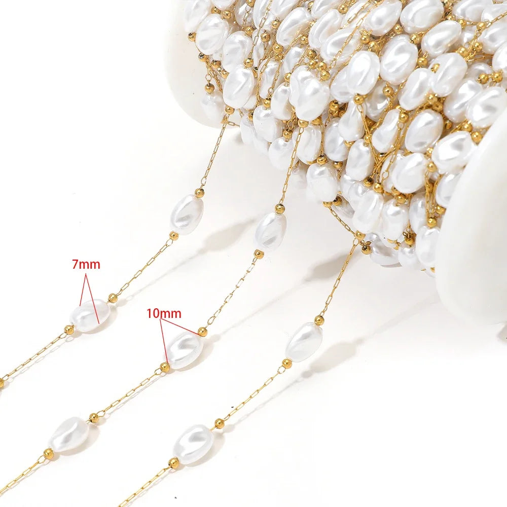 Artificial pearl chain with gold links and 7mm white oval beads