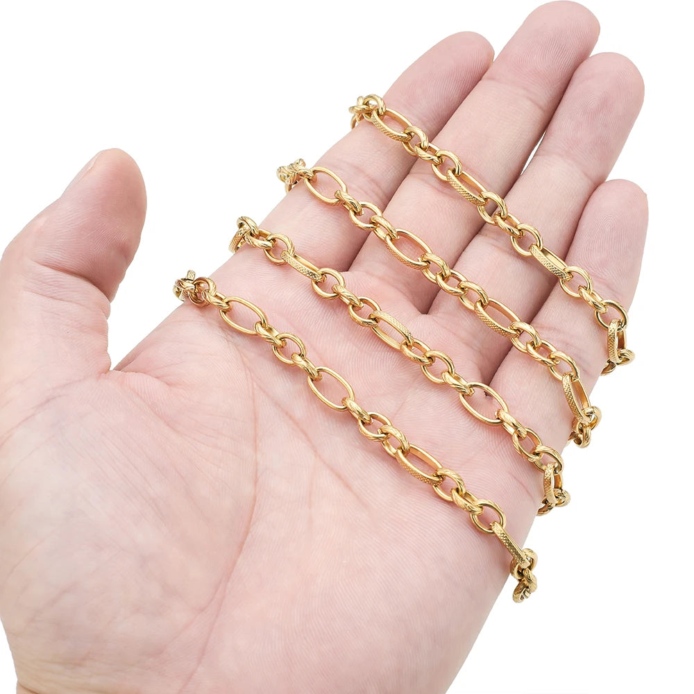 Gold flat link chain held in hand, small oval links with clasp
