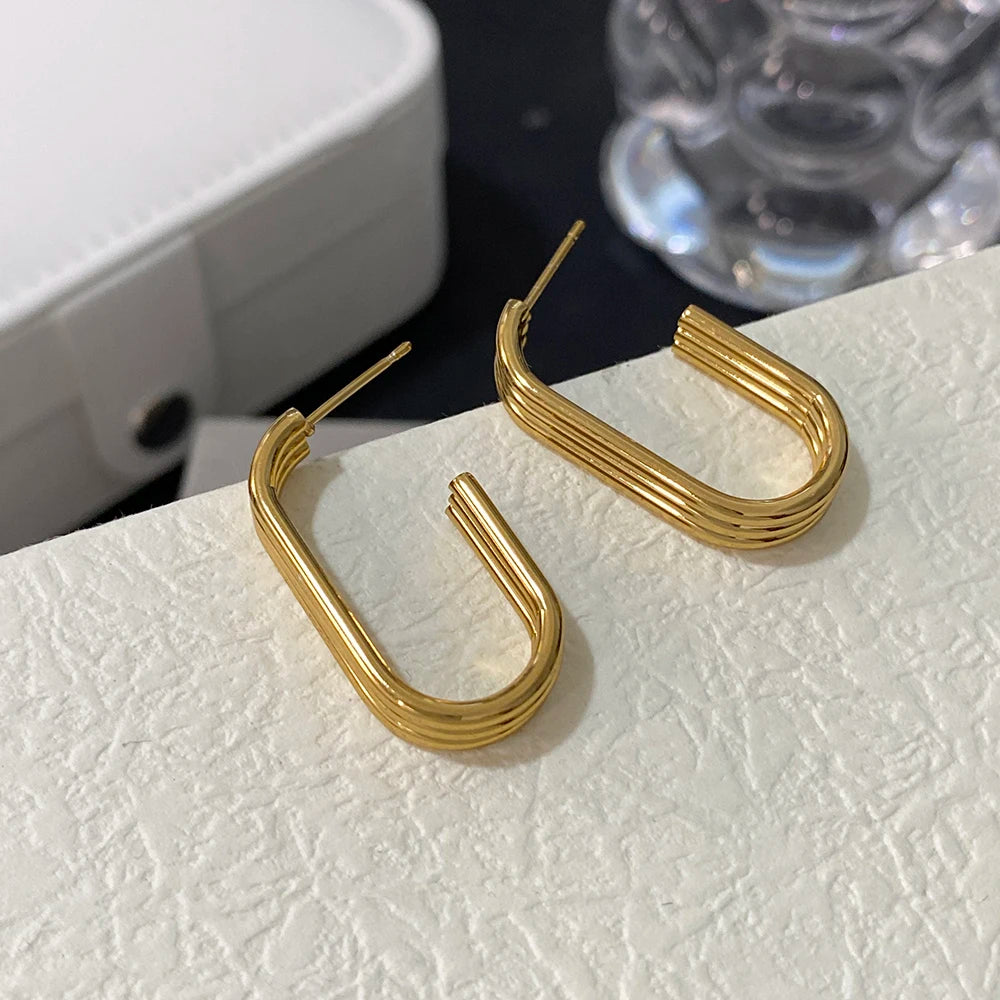 Gold-tone U-shaped hoops with narrow posts and parallel raised bands