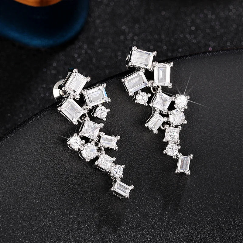 Geometric cubic zircon dangle earrings in silver tone with square and round stones