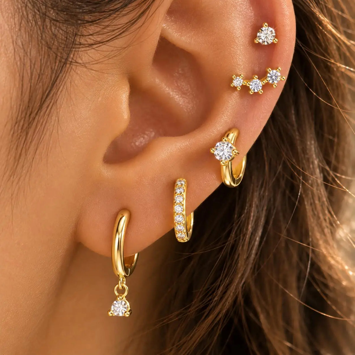 Gold-plated CZ huggie hoop earrings set, mixed hoops and dangling mini-stones on ear