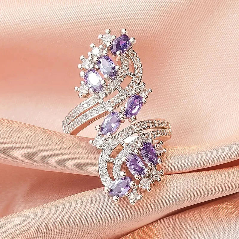 Rose-gold cubic zirconia ring with stacked purple oval stones and scalloped halo details