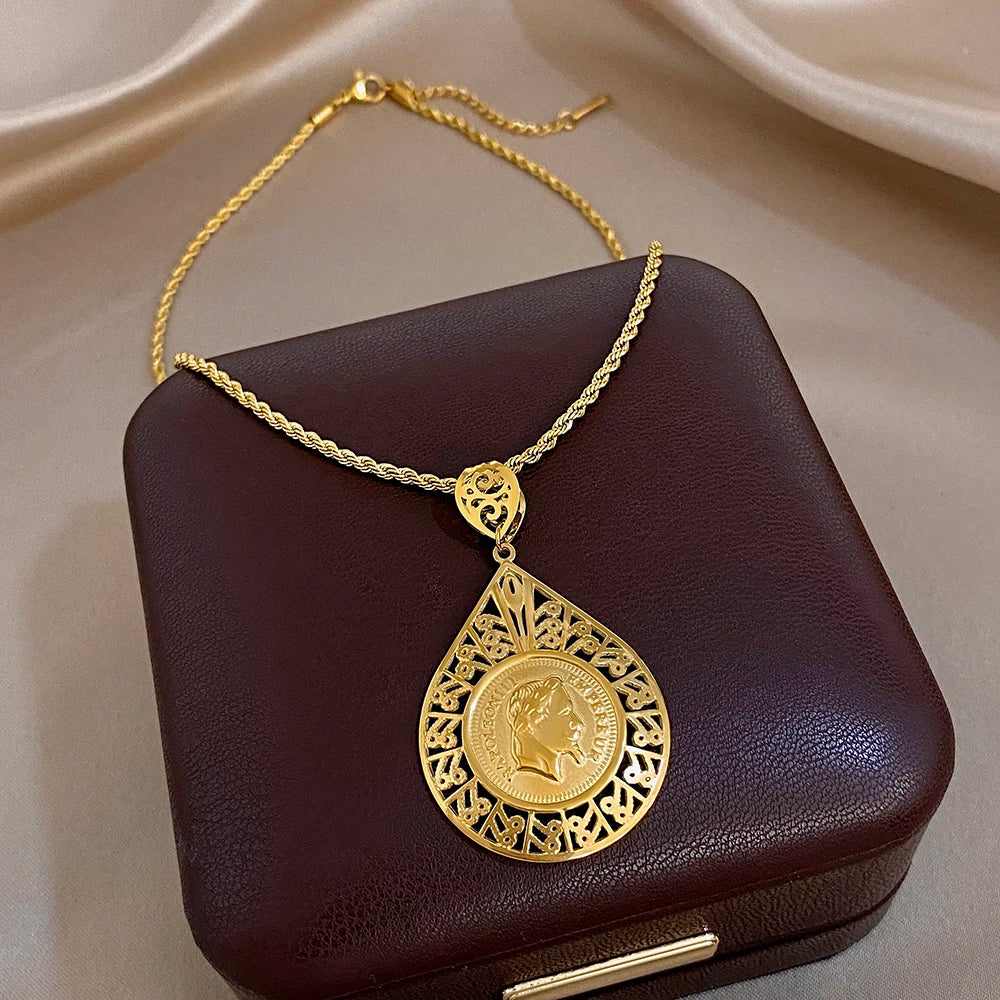 Gold plated waterdrop pendant necklace with hollow floral filigree and coin center