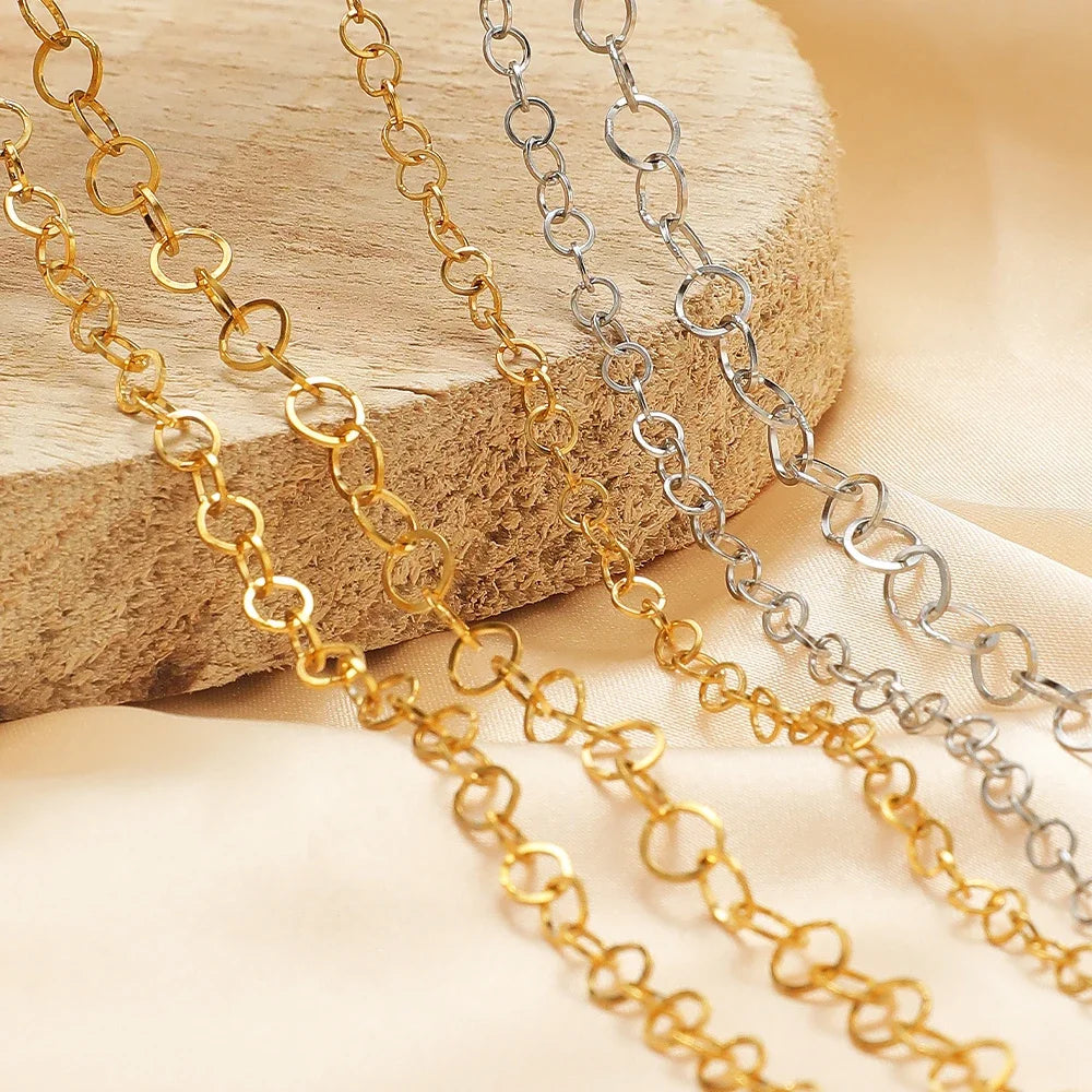 Gold and silver o-ring chain links on a wooden block