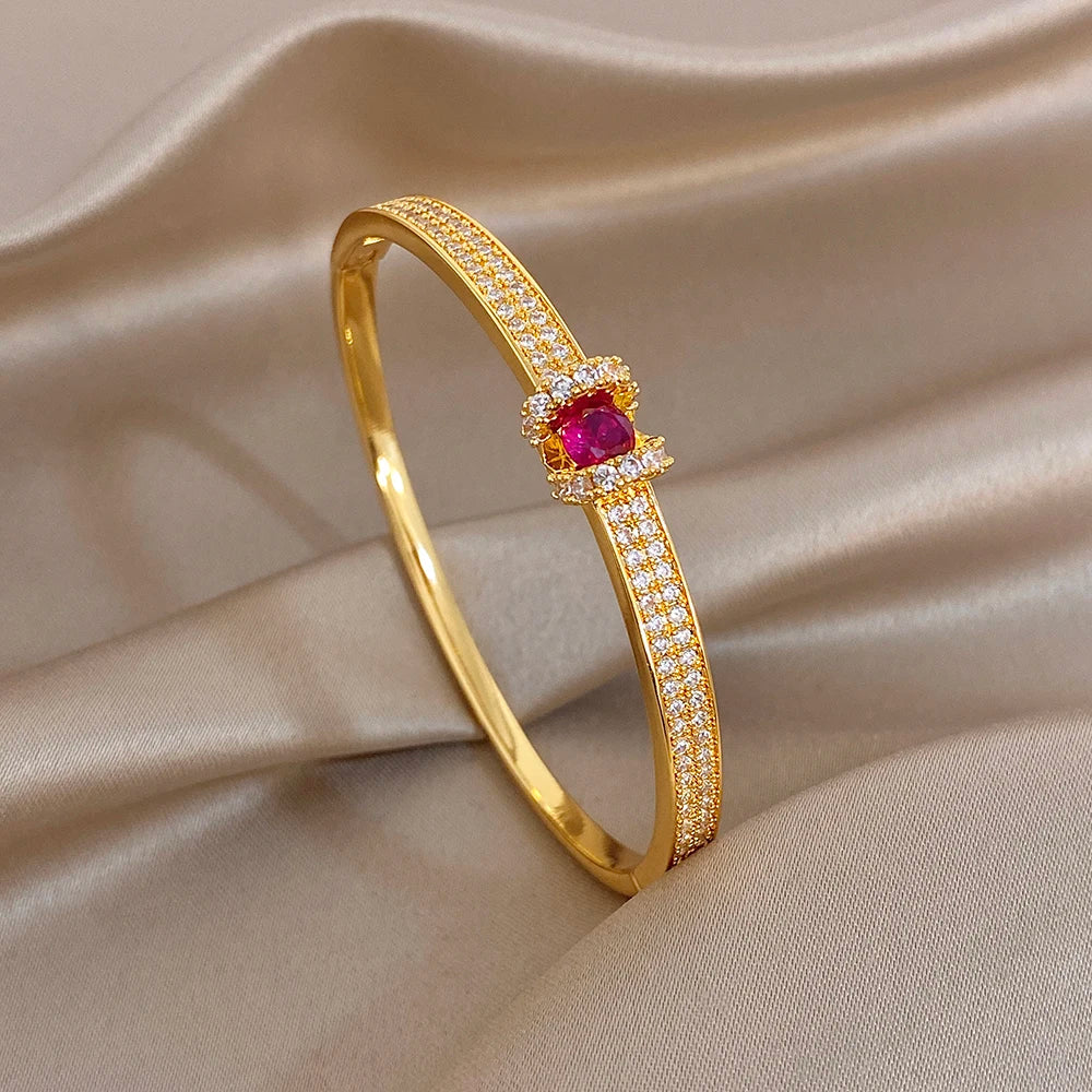 Gold zircon stacked cuff bangle with pink round center stone and crystal pave accents