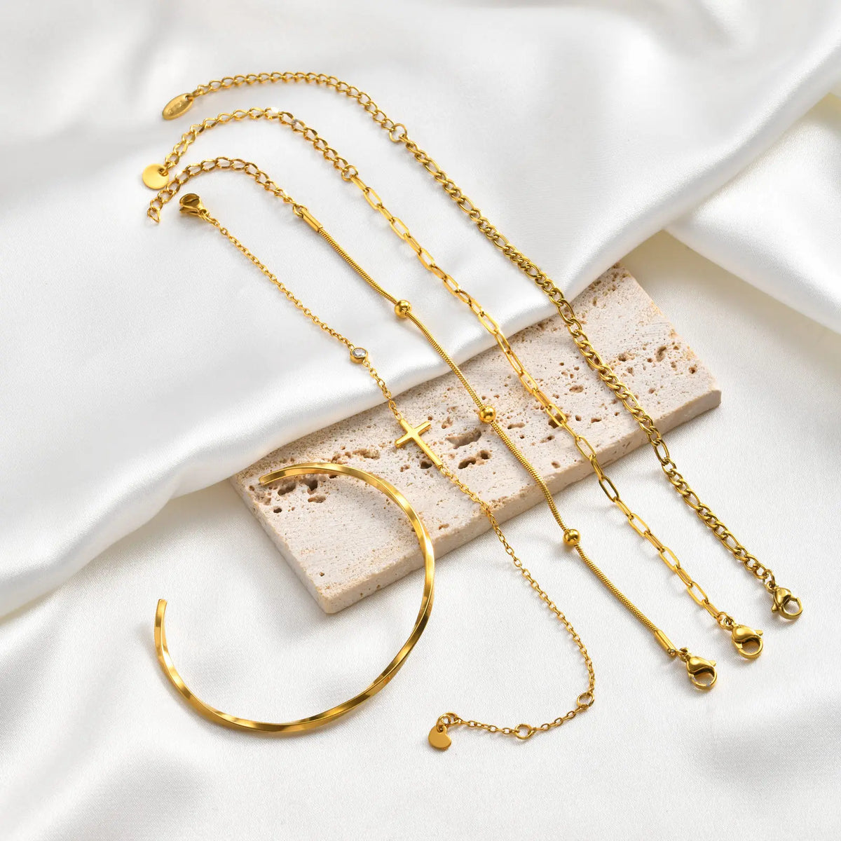 Five-piece gold bracelet set with cross charms and chain link designs