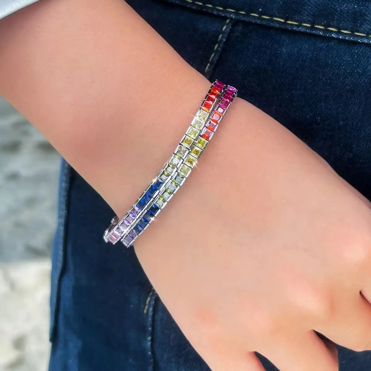 Rainbow square-cut zirconia tennis bracelet stack worn on wrist