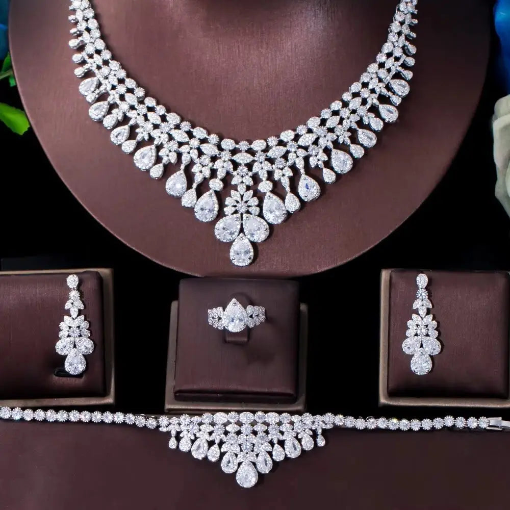 Rhinestone necklace with teardrop fringe, plus matching earrings and ring on display