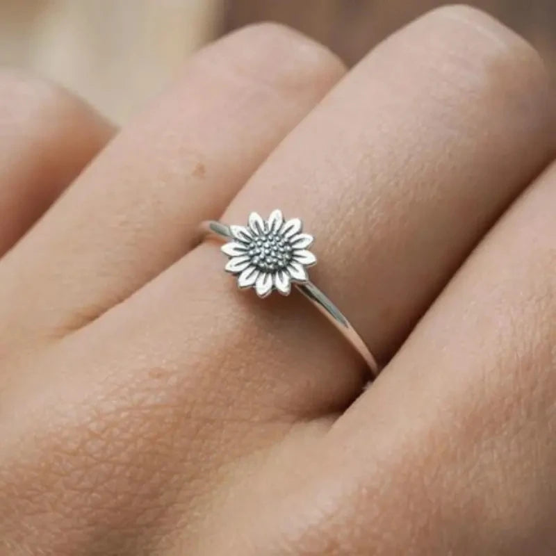Silver sunflower dainty finger ring with textured flower center on slim band