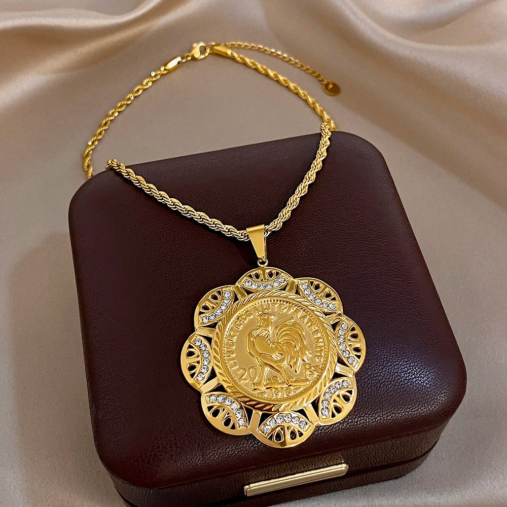 Gold plated statement necklace with large round filigree pendant and central coin