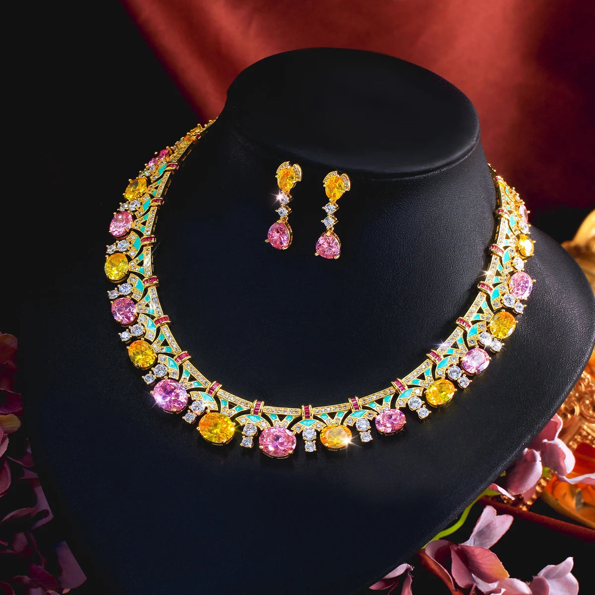 Gold-tone multicolor cubic zirconia necklace and drop earrings set on black display stand