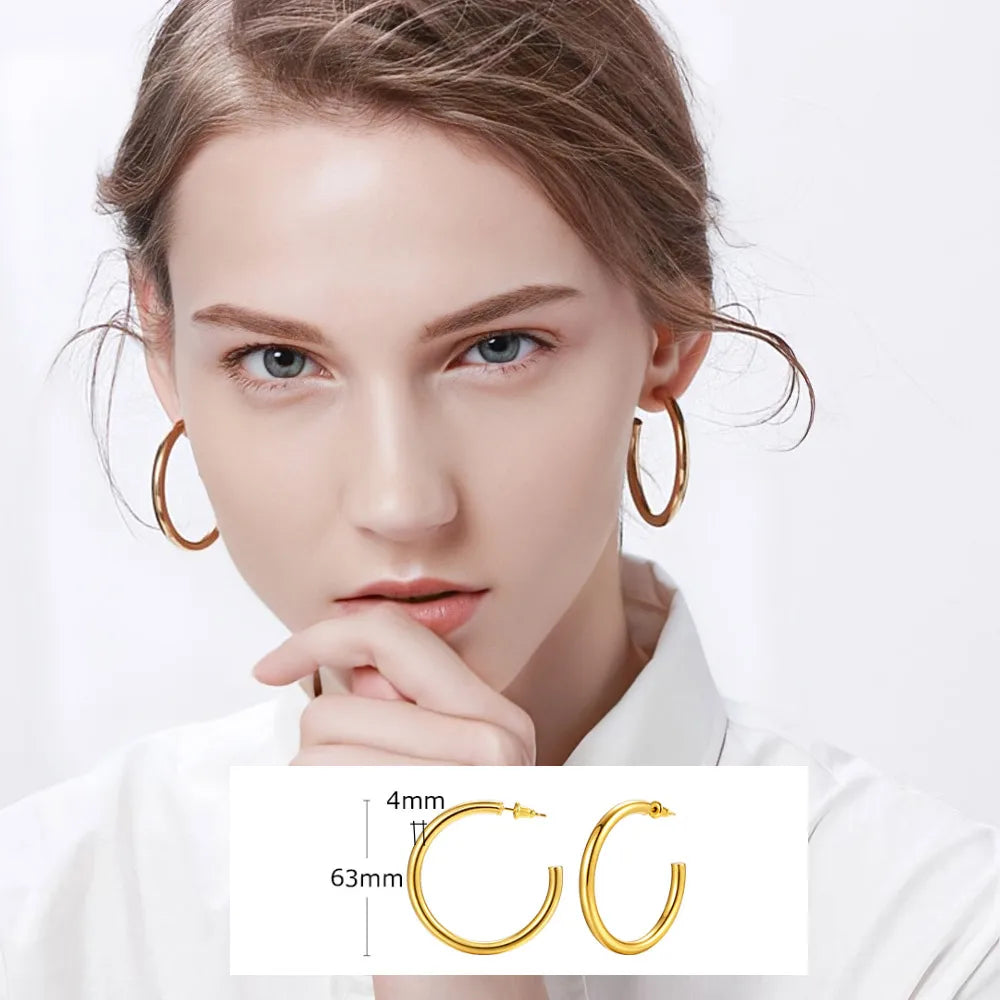 Large thin gold-tone hoop earrings, shown with a 63 mm size guide.