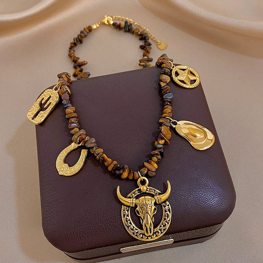 Gold-tone charm beaded necklace with bull head pendant and cactus, star, teardrop charms