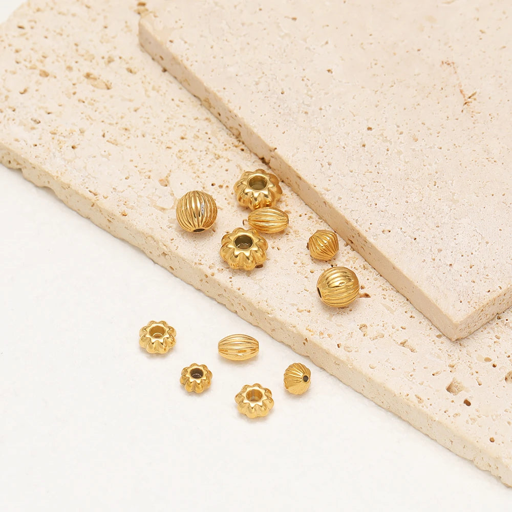 Gold-plated pumpkin spacer beads with striped texture and floral spacer beads, assorted