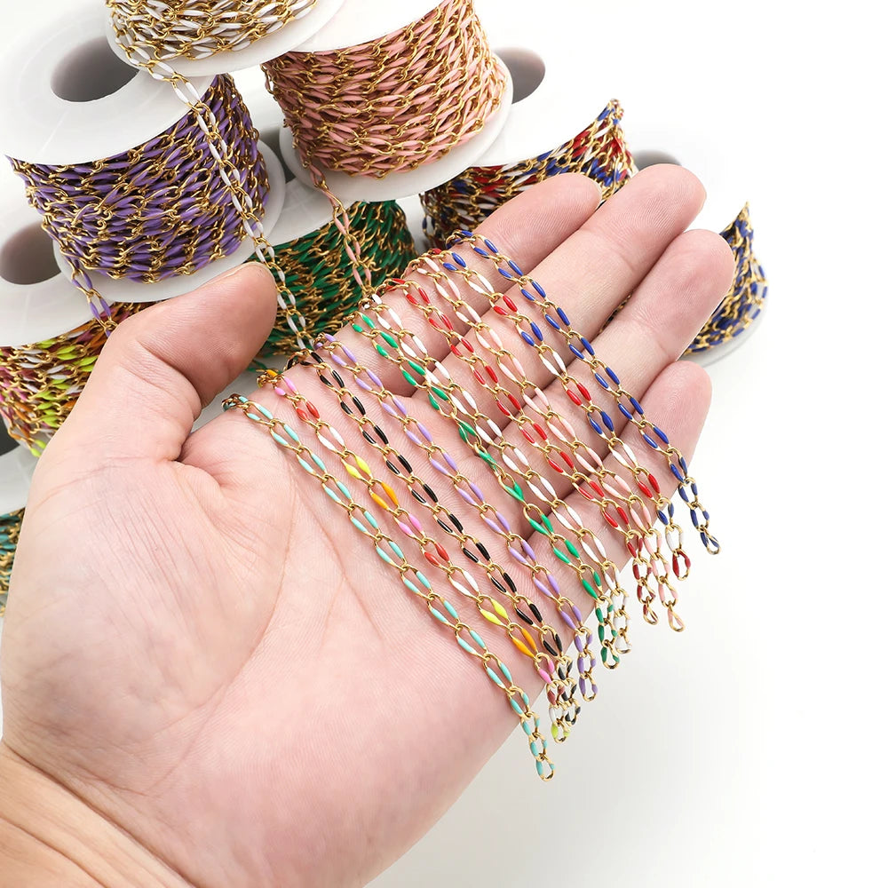 Twisted enamel chain multicolor links draped on hand over DIY jewelry spool