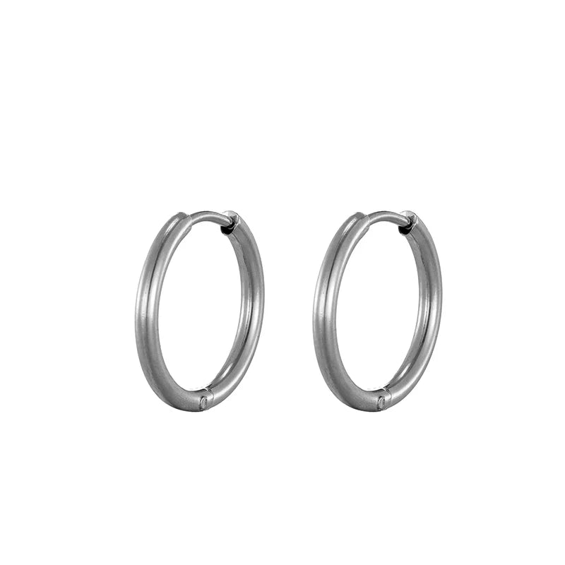 Silver-tone oval hoop earrings with smooth glossy finish, hinged clasp