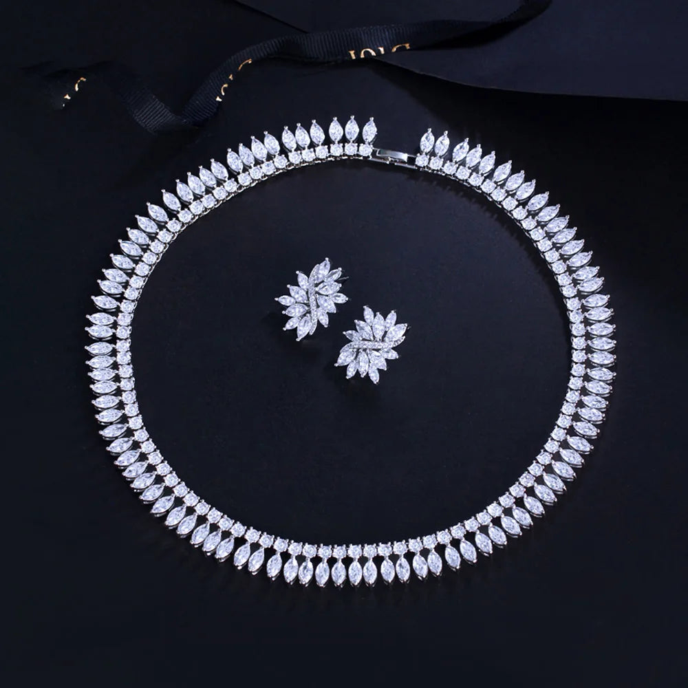 Leaf-shaped cubic zirconia necklace and matching floral stud earrings, arranged as a set