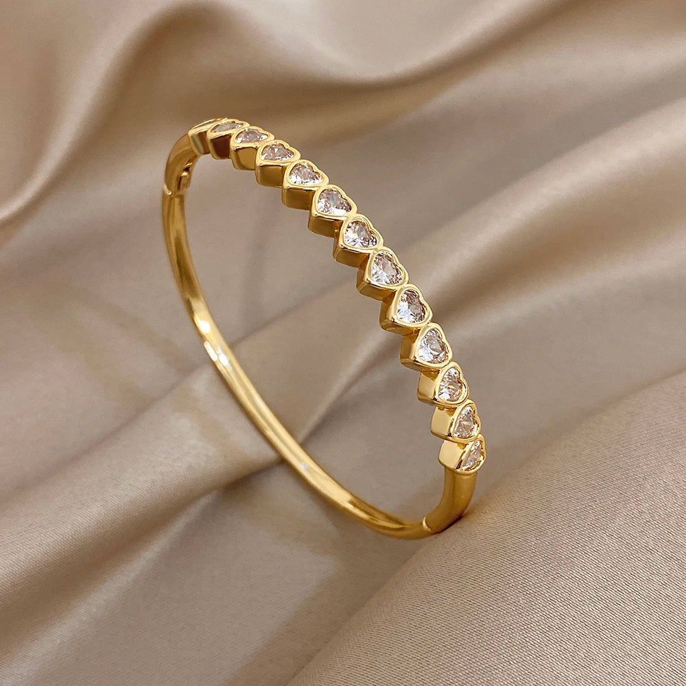 Gold-tone heart crystal inlay cuff bracelet, side view