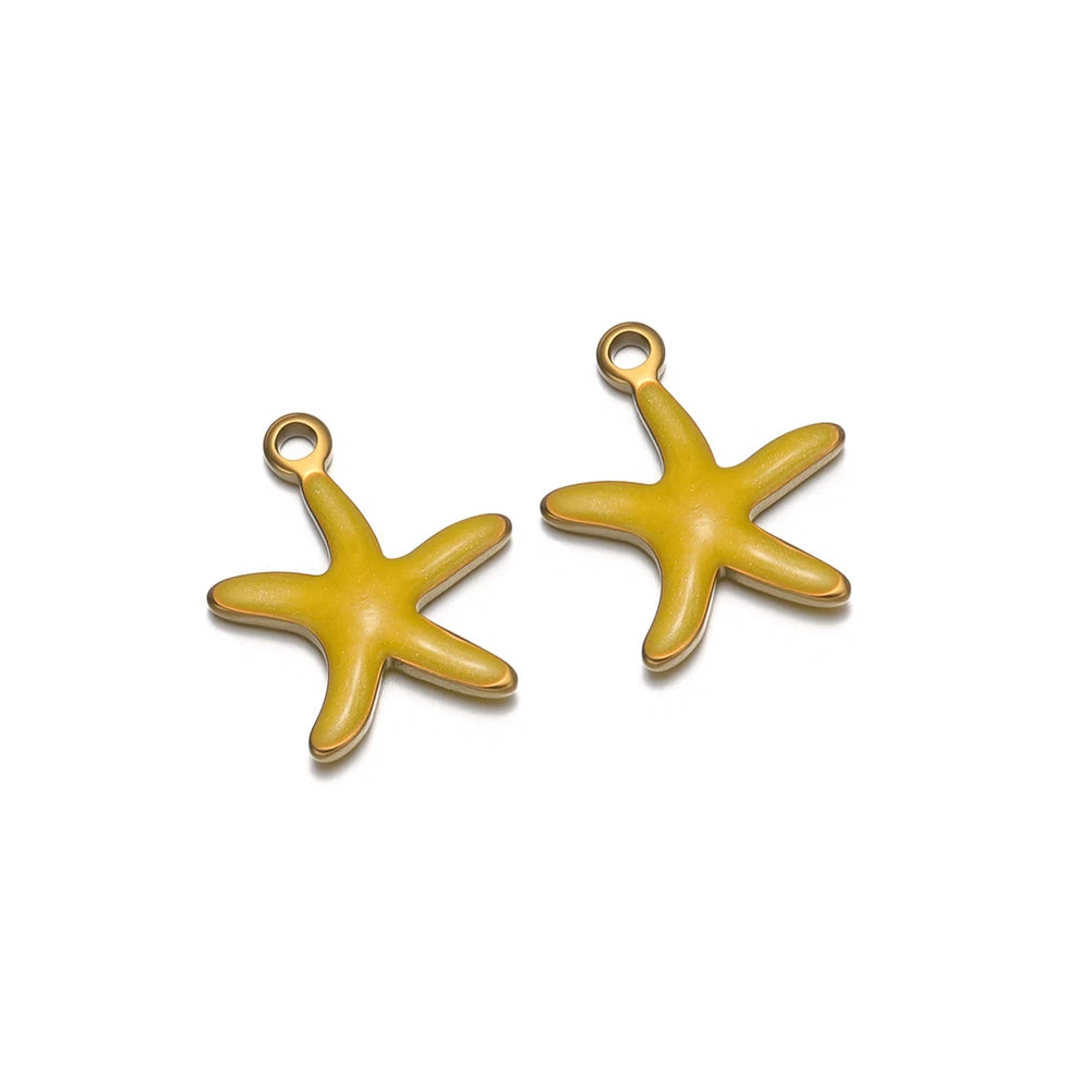 Two yellow starfish pendant charms with gold-tone loop openings