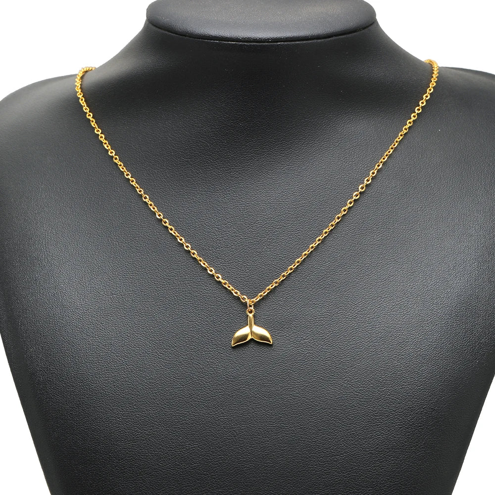 Gold-tone dolphin charm pendant on a chain necklace
