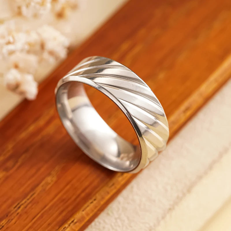 Diagonal groove band ring in stainless steel, angled ridges and high-shine finish