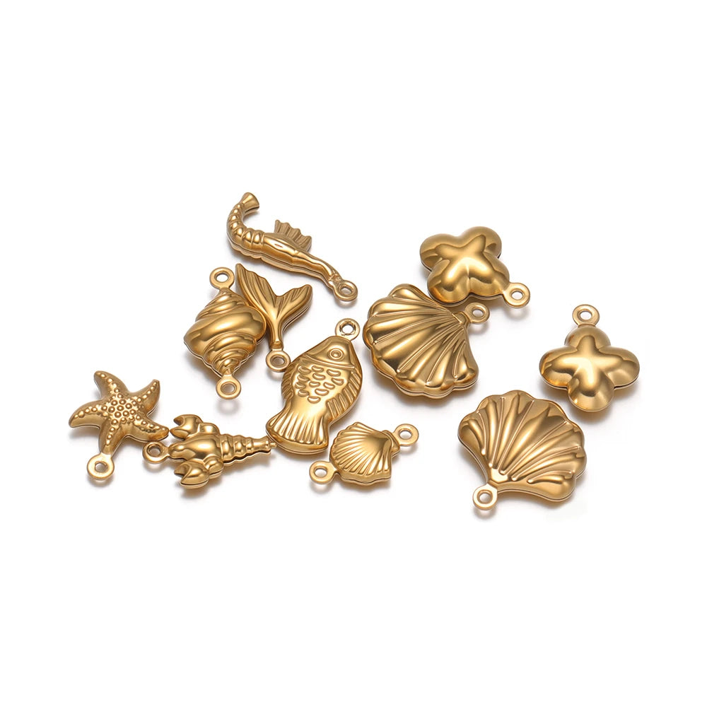 Gold hollow sea-life pendant charms, starfish, shells, and fish silhouettes, assorted