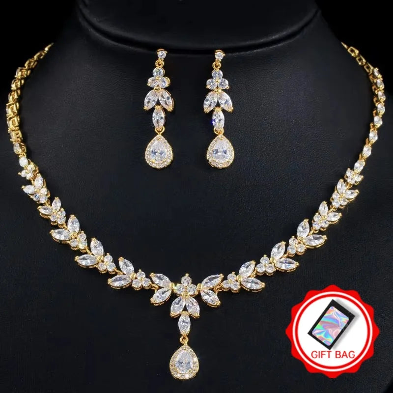 Gold-tone cubic zirconia necklace set with leaf details and matching drop earrings