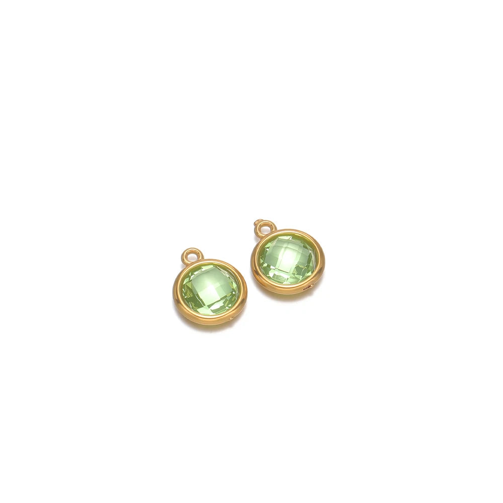 Round light green faceted glass charm pendants with gold-tone frames and loop hooks