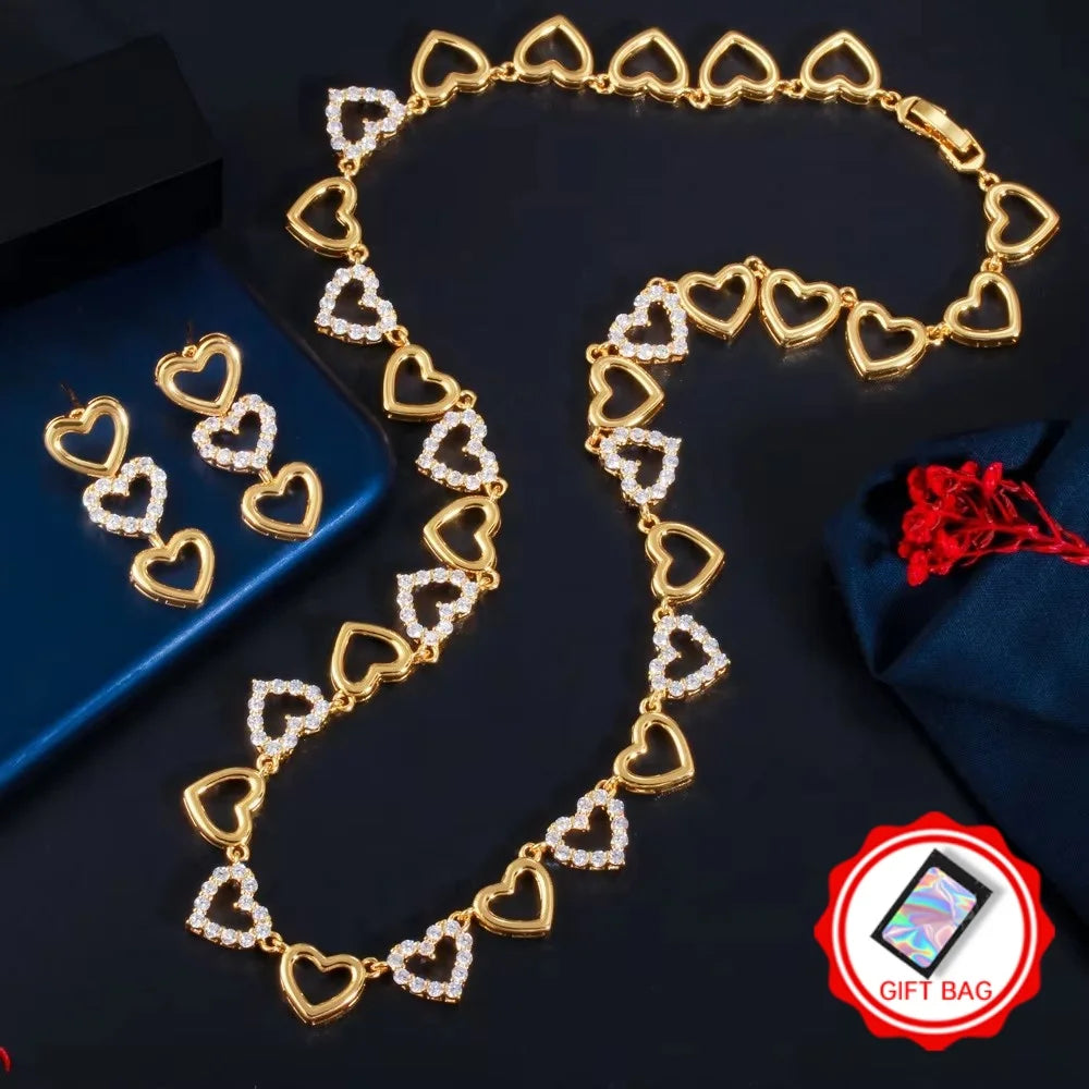 Gold-tone necklace and matching heart earrings with clear stones