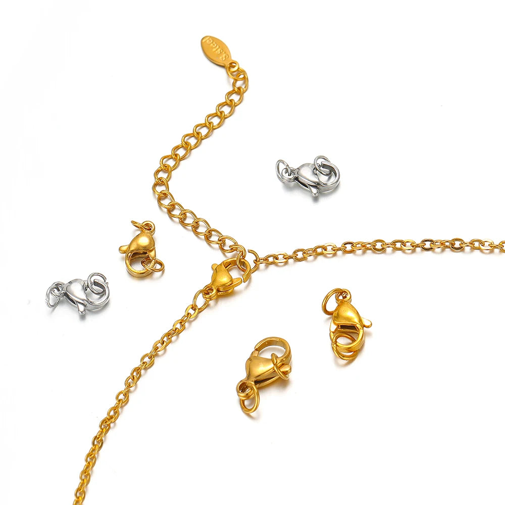 Gold lobster clasp on chain with small gold and silver clasp pieces, with jump rings
