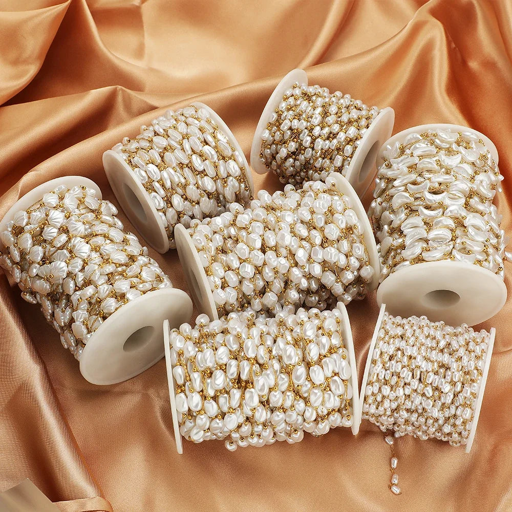 Assorted spools of white artificial pearl chain with gold-tone accents for DIY jewelry
