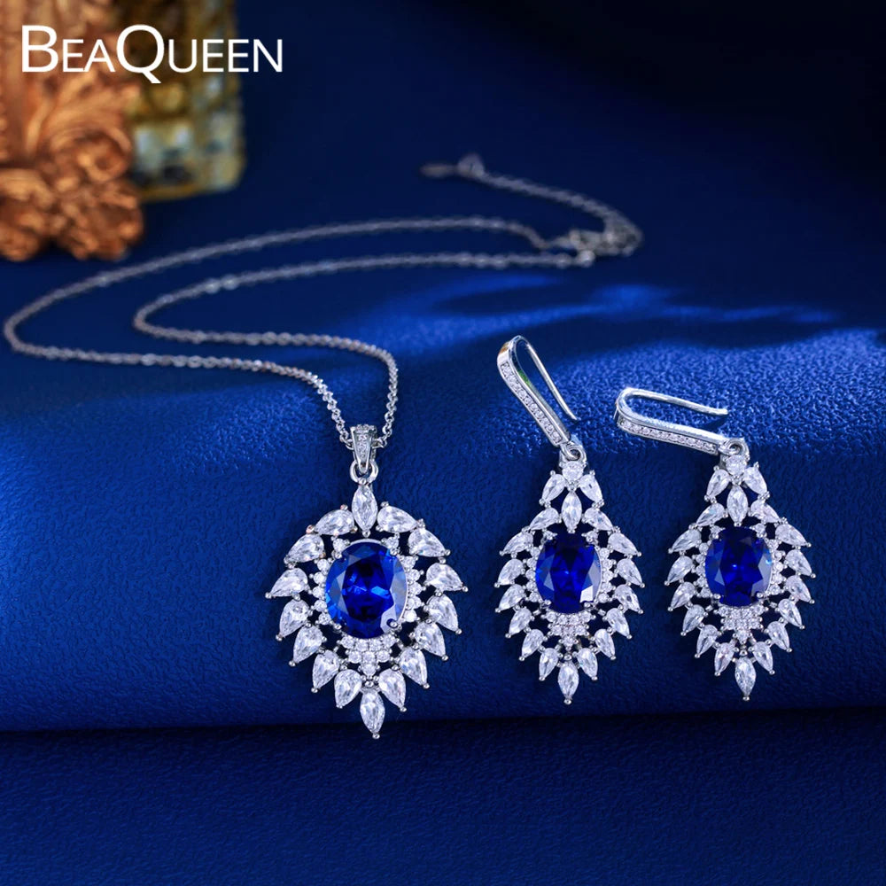 Silver-tone blue CZ pendant necklace with matching marquise halo drop earrings