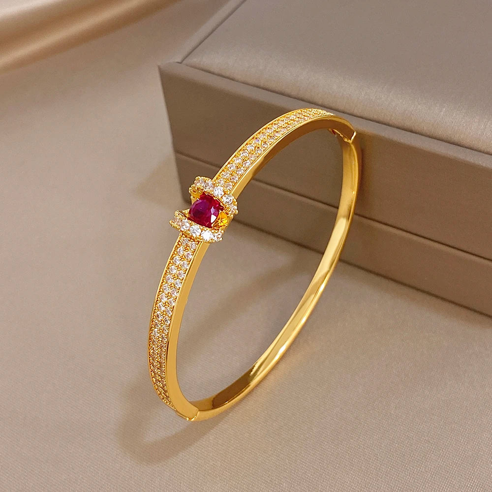 Gold zircon cuff bangle with geometric crystal pave and pink round center stone