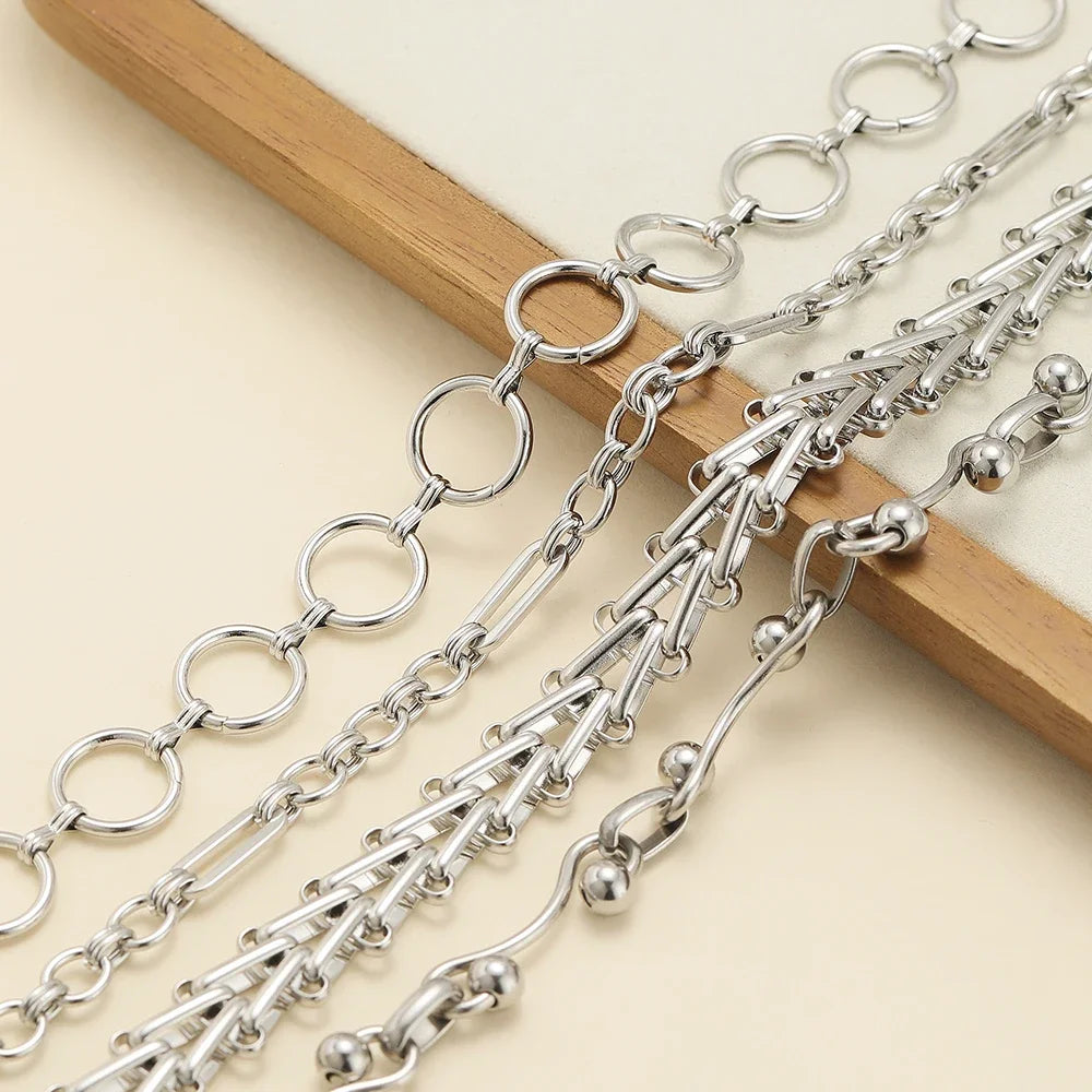 Stainless steel chain necklace with round-link and bar-link segments, extension rings