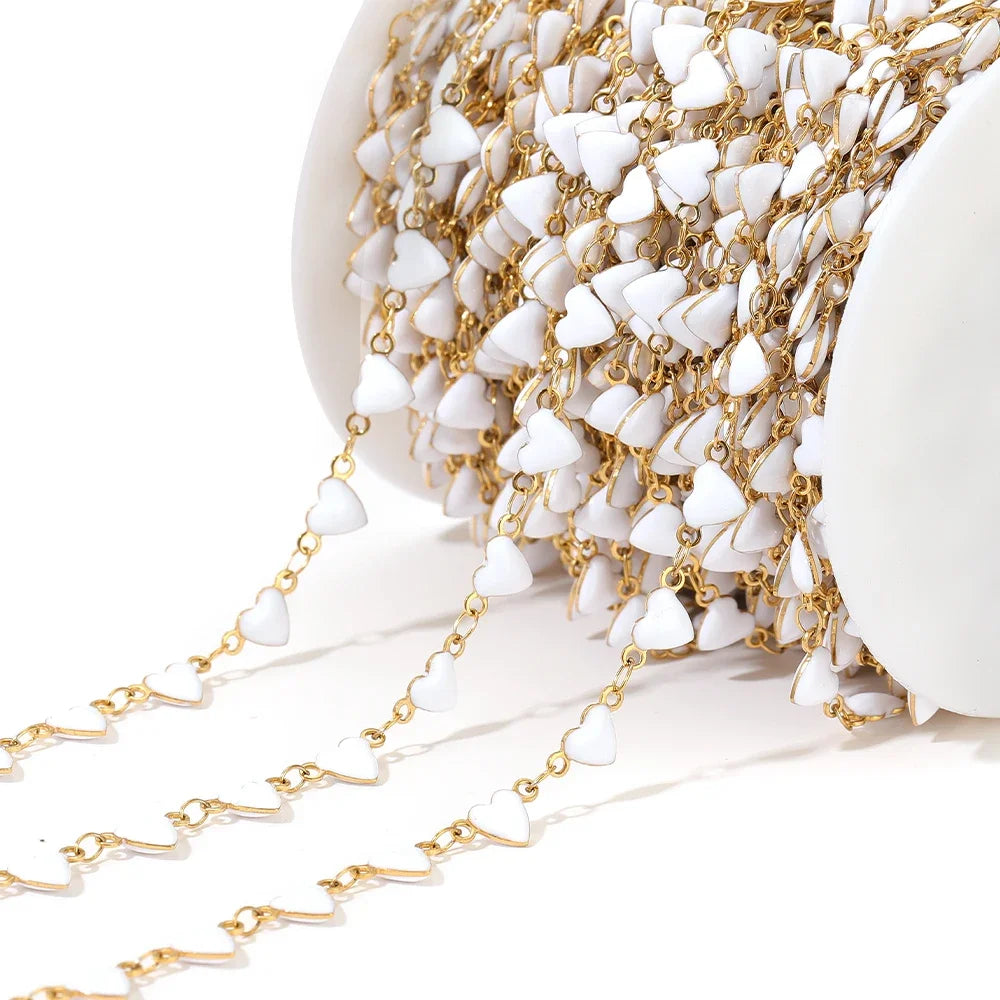 White enamel heart charm chain with gold-tone links and small heart drops