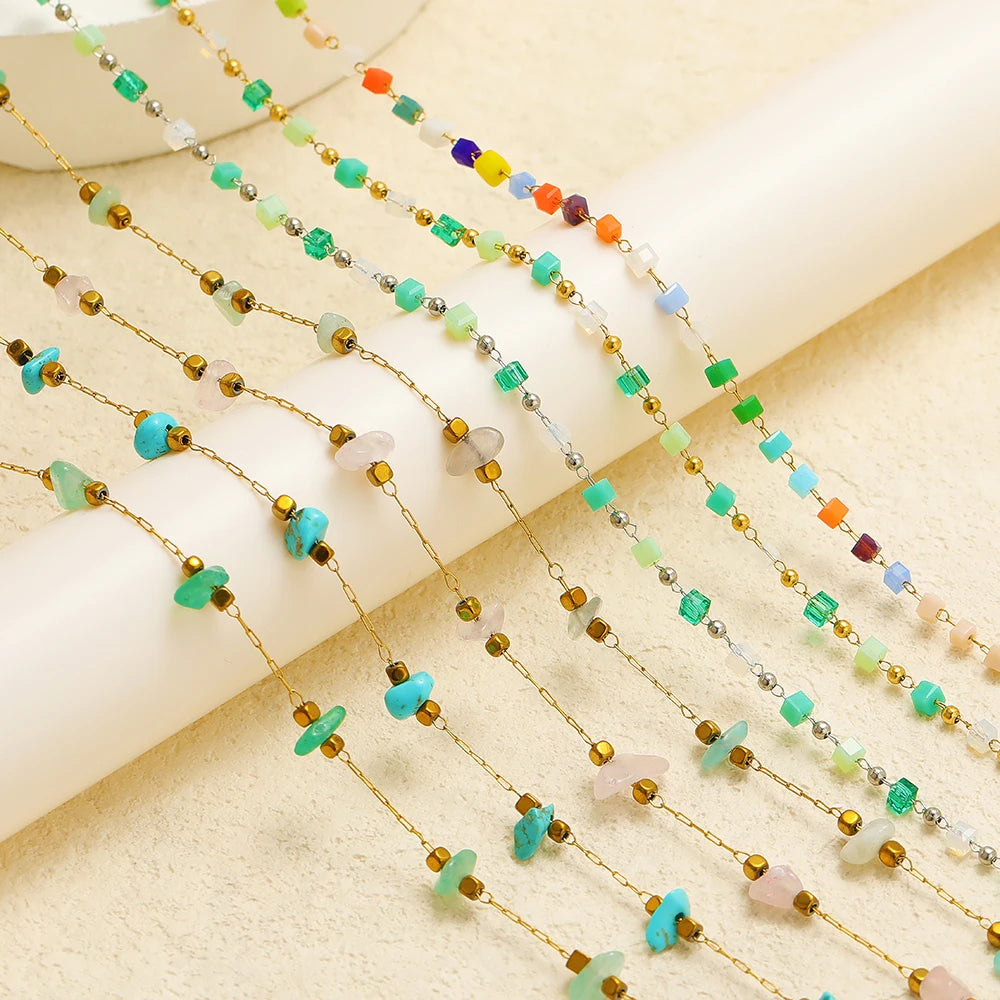 Multiple irregular glass bead link chain strands with green, white, blue and gold-tone beads
