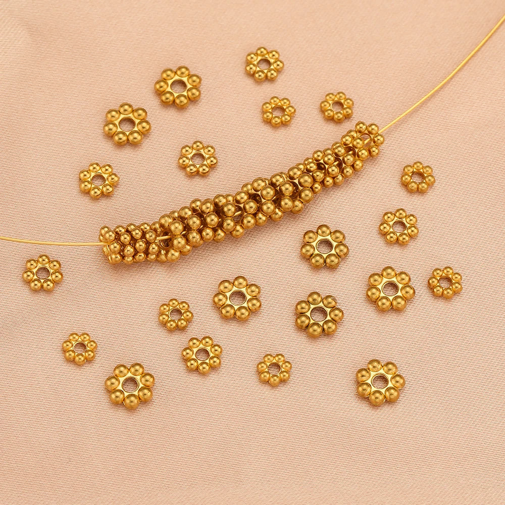 Gold flower-shaped spacer beads, round bead cluster design for DIY jewelry making.