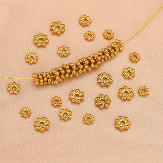 Gold flower-shaped spacer beads, round bead cluster design for DIY jewelry making.