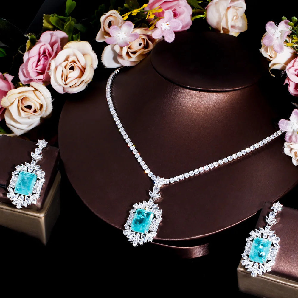 Cubic zirconia jewelry set with teal square stones, silver-tone necklace and matching earrings