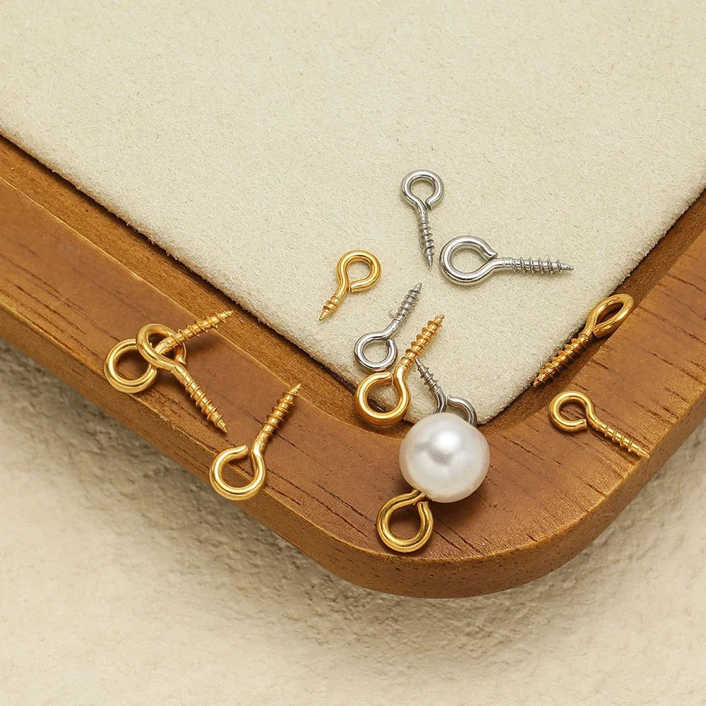 Gold and silver screw eye pins with threaded shafts and loop eyes, with pearl bead