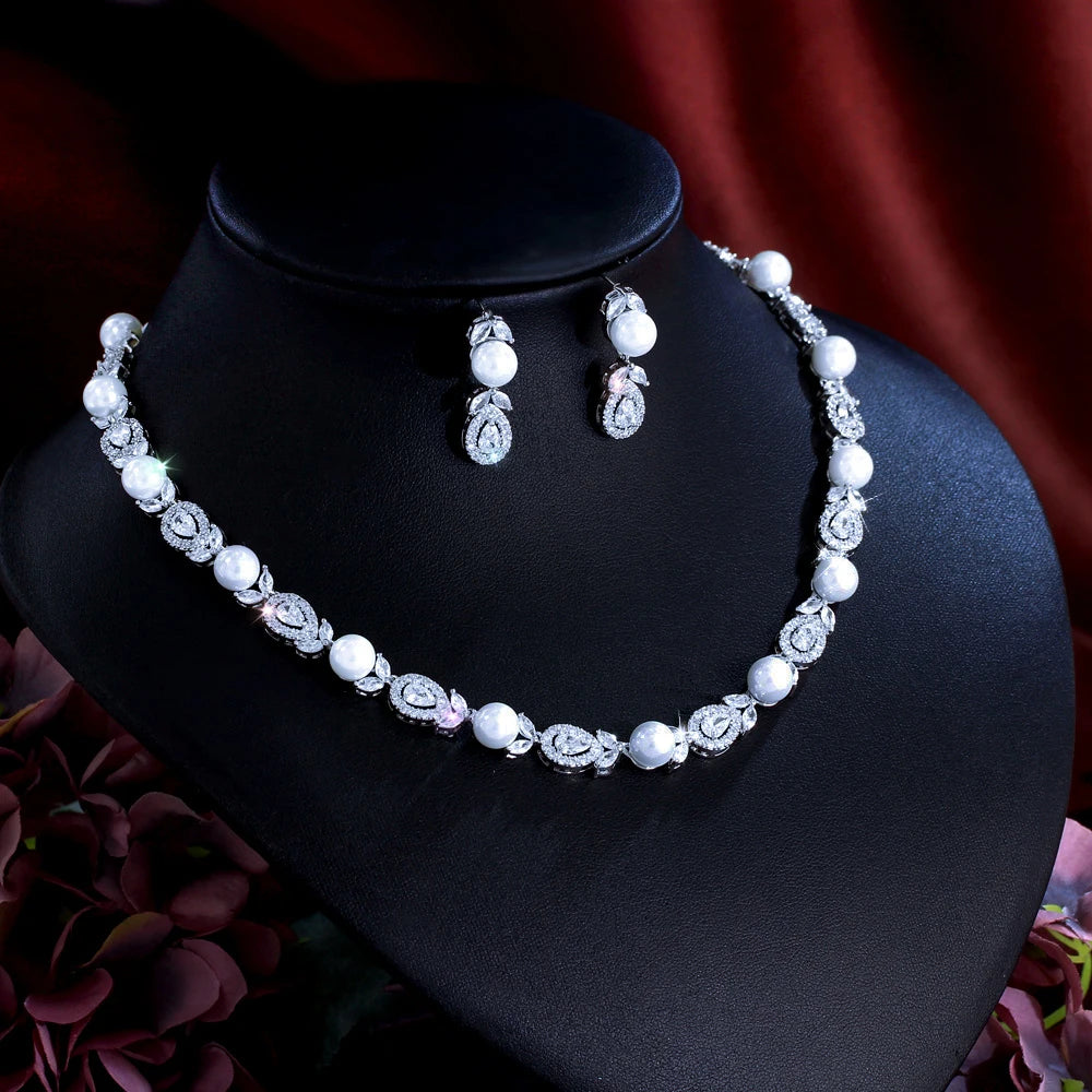 Pearl bead and cubic zirconia necklace with matching teardrop earrings on black display