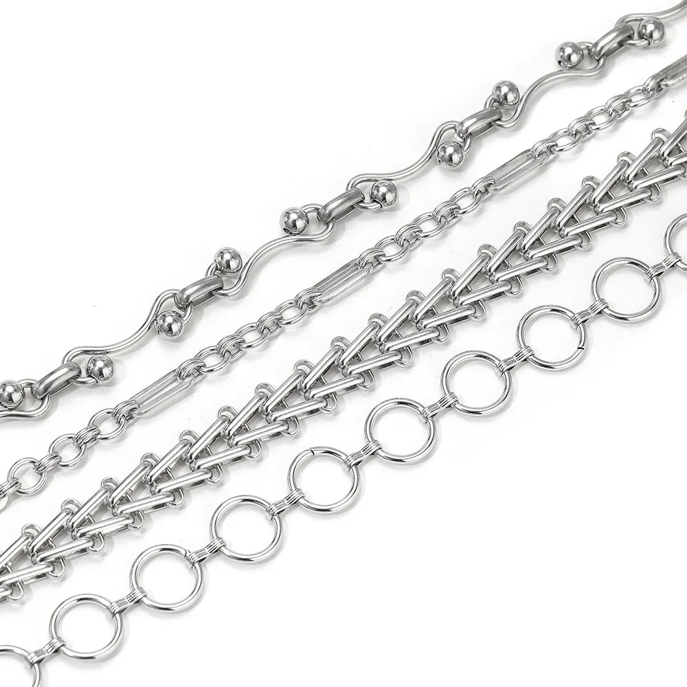 Stainless steel chain necklace with mixed link patterns and round connector rings